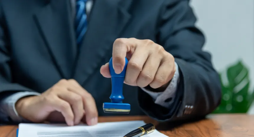 Hand stamping a document.